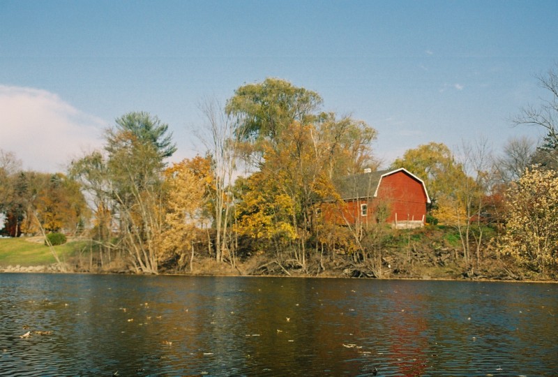 An old fashioned red barn along the river