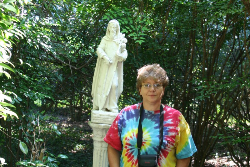 Mary poses with a statue