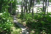 The trail walkway follows a farmer's fence